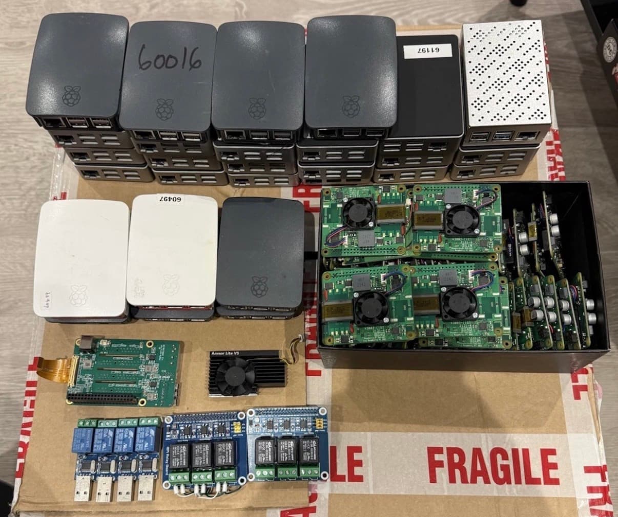 Pi 4 official cases stacked next to CM4 carrier boards and relay modules