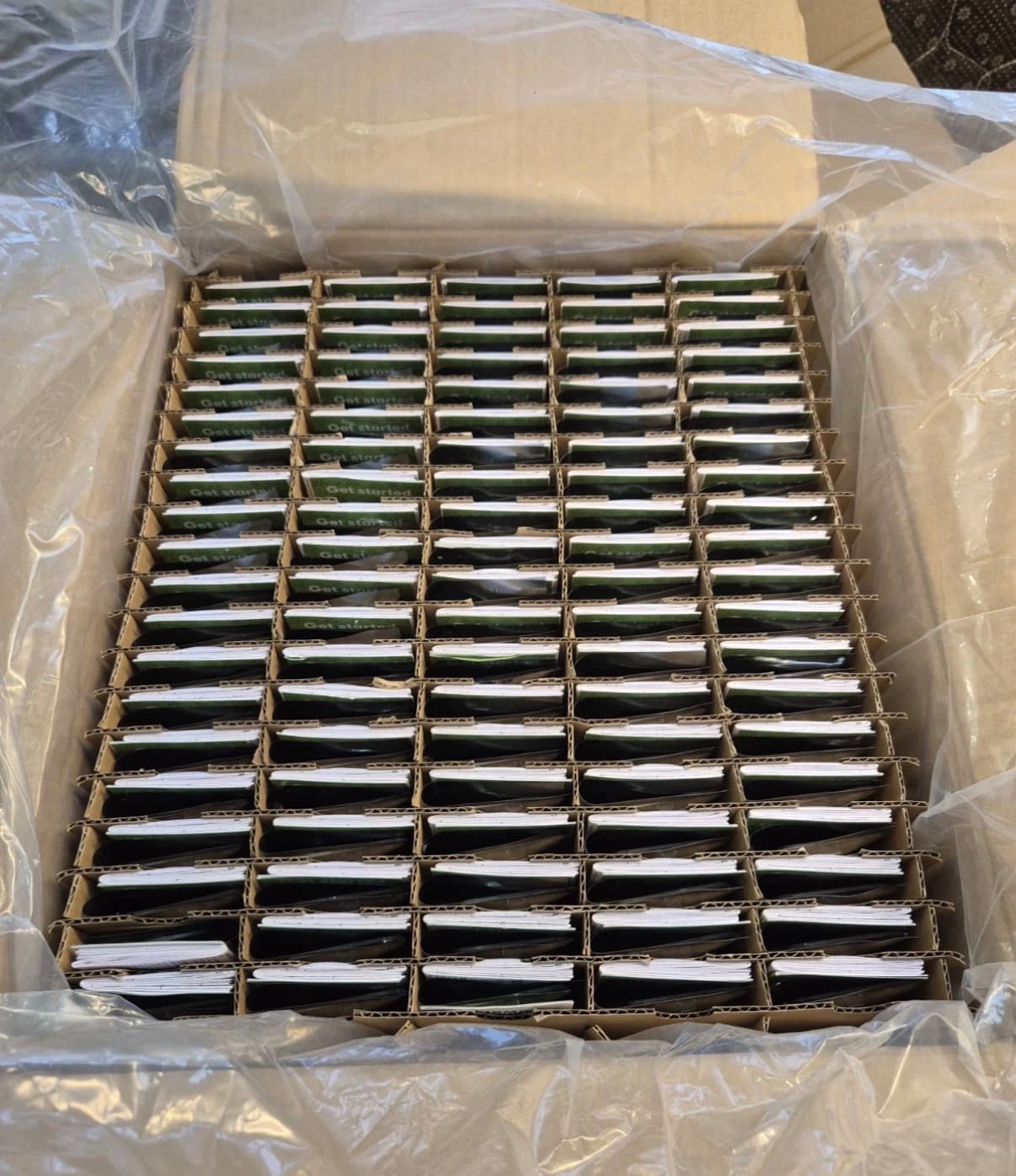 Pallet of BBC micro:bit V2 in green retail boxes, schools programme reverse logistics